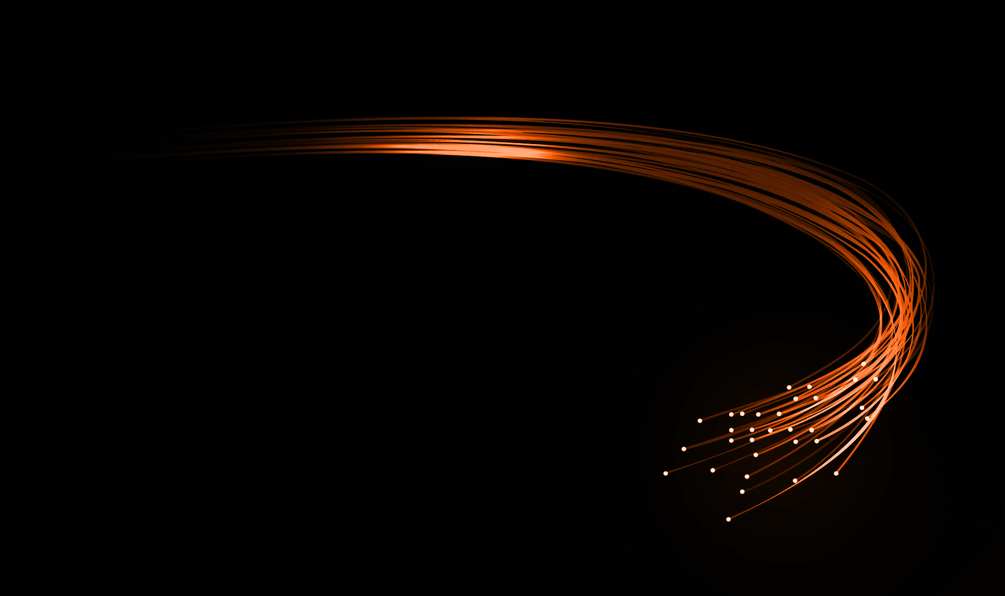 Orange fibre-optic light trails on dark background